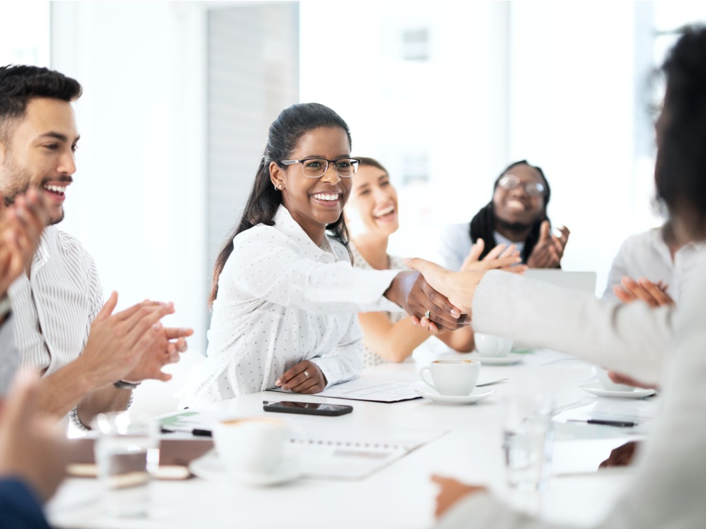 a women employee shaking hands with another employee