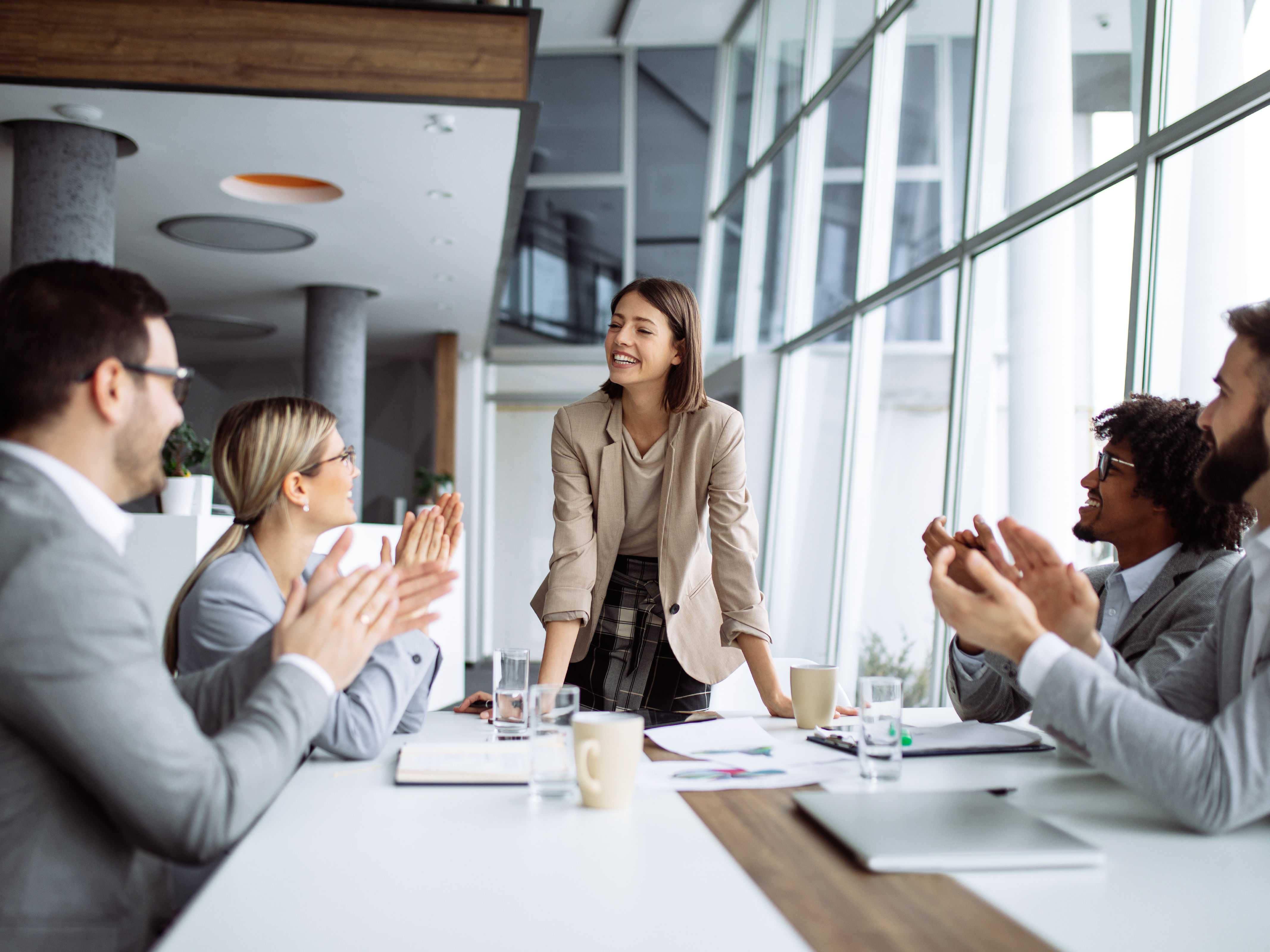 Group of business people applauding team leader.