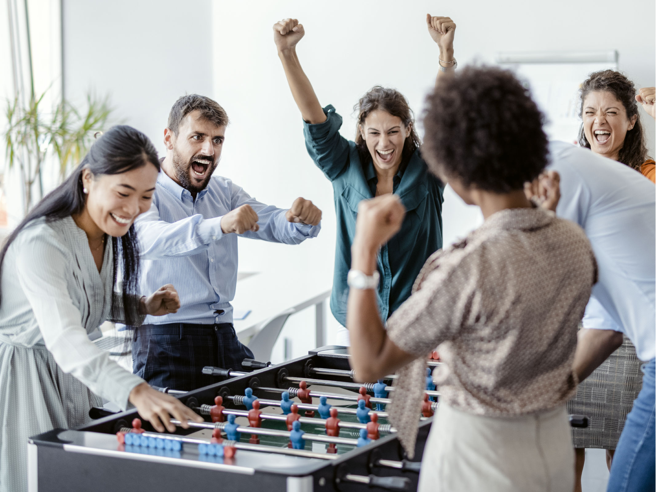 Employees playing Table Football.